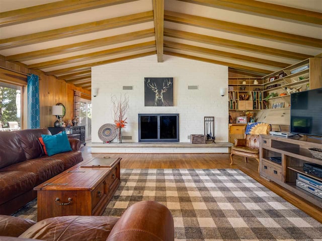 living room featuring hardwood / wood-style floors, vaulted ceiling with beams, and wood walls