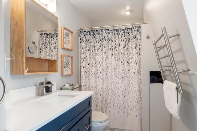 bathroom featuring toilet, vanity, and walk in shower