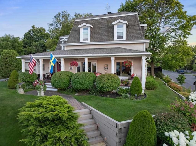 view of front of property with covered porch and a front lawn