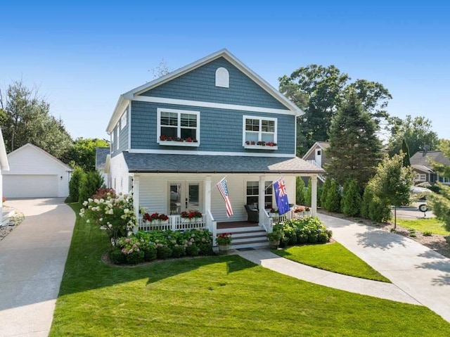 view of front of property featuring an outbuilding, a porch, a front lawn, and a garage