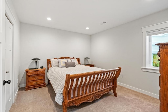 bedroom with visible vents, recessed lighting, light colored carpet, and baseboards