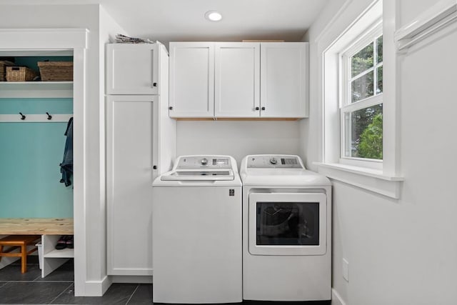 clothes washing area with recessed lighting, dark tile patterned floors, baseboards, cabinet space, and washing machine and clothes dryer