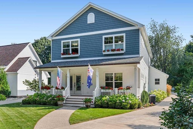 view of front facade with covered porch and a front lawn