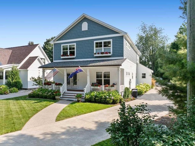 view of front of home featuring covered porch and a front yard