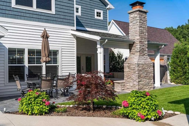 back of house with a shingled roof and french doors