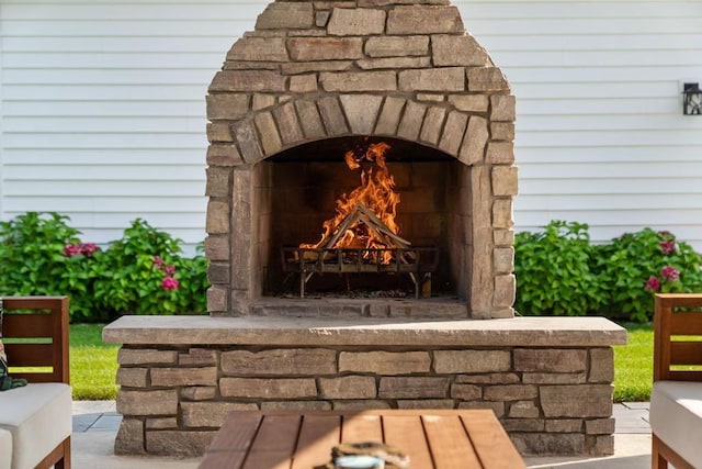 exterior details featuring an outdoor stone fireplace