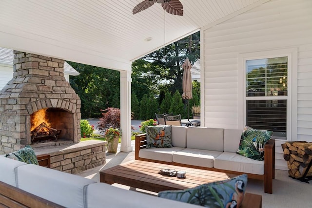 view of patio / terrace with ceiling fan, an outdoor living space with a fireplace, and outdoor dining space