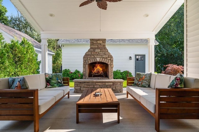 view of patio with an outdoor living space with a fireplace and ceiling fan