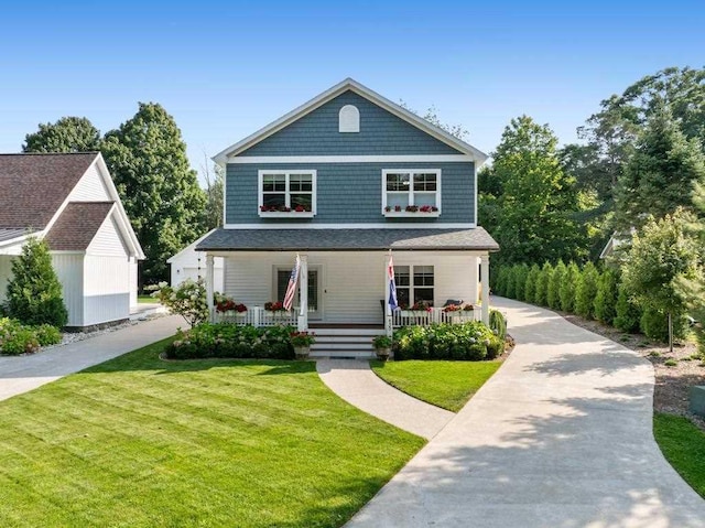 view of front facade with a front yard and covered porch