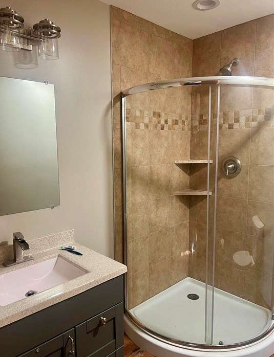 bathroom featuring vanity and an enclosed shower