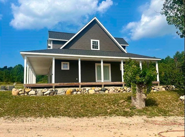 back of property with a porch