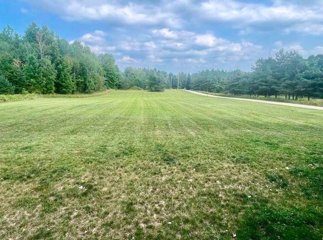 exterior space featuring a lawn and a rural view