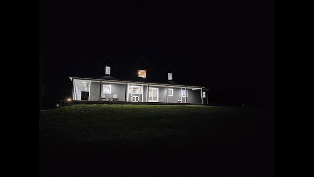 cape cod home with a lawn