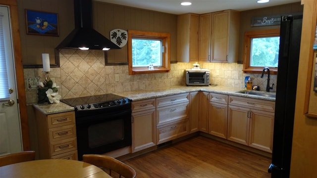 kitchen with light wood-type flooring, sink, custom range hood, and black range with electric cooktop