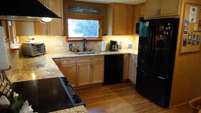 2767 Lake Grove, Petoskey, MI 49770 - kitchen with black appliances, a sink, range hood, wood finished floors, and tasteful backsplash
