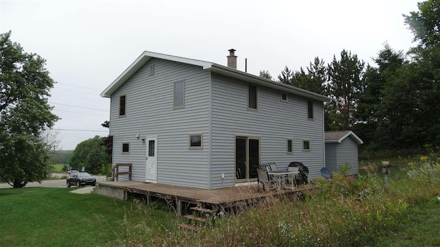 2767 Lake Grove, Petoskey, MI 49770 - back of house with a deck, a chimney, and a lawn