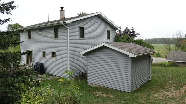 rear view of house featuring a yard