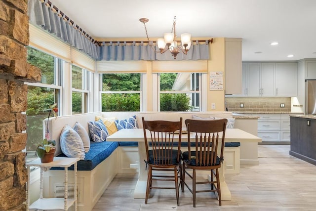 645 Woodhill Ct, Harbor Springs, MI 49740 - dining area featuring a notable chandelier, recessed lighting, breakfast area, and light wood-type flooring