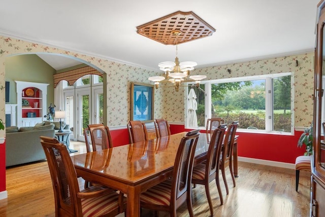 645 Woodhill Ct, Harbor Springs, MI 49740 - dining room featuring light wood finished floors, a notable chandelier, plenty of natural light, and wallpapered walls