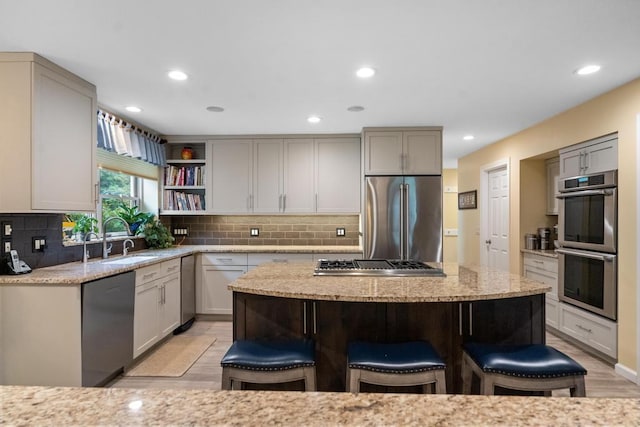 645 Woodhill Ct, Harbor Springs, MI 49740 - kitchen with a breakfast bar, backsplash, stainless steel appliances, and a sink