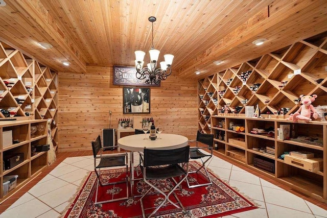 645 Woodhill Ct, Harbor Springs, MI 49740 - wine cellar with light tile patterned floors, a notable chandelier, wood ceiling, and wooden walls