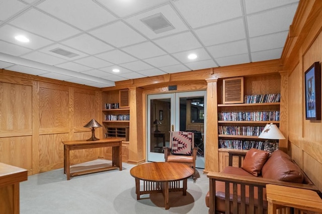 645 Woodhill Ct, Harbor Springs, MI 49740 - sitting room with visible vents, wood walls, and carpet flooring