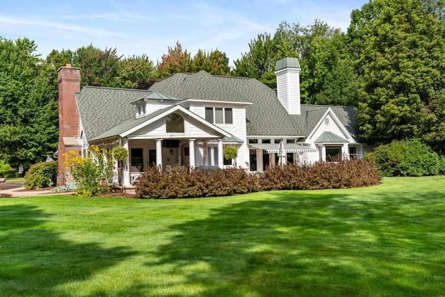 645 Woodhill Ct, Harbor Springs, MI 49740 - rear view of house featuring a yard and a chimney