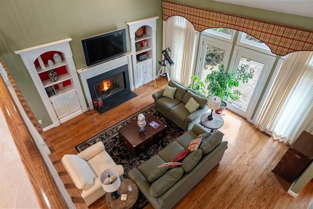 645 Woodhill Ct, Harbor Springs, MI 49740 - living area featuring a fireplace with flush hearth and wood finished floors