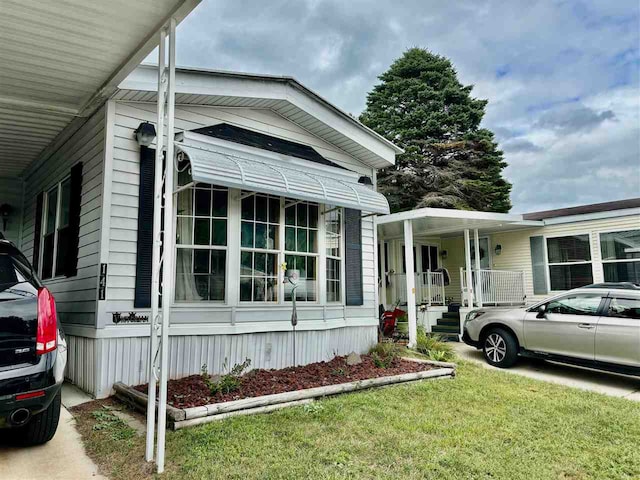 view of home's exterior with a yard and a porch