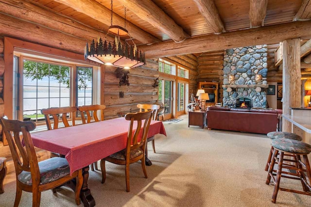 dining room featuring log walls, carpet flooring, wood ceiling, and a fireplace