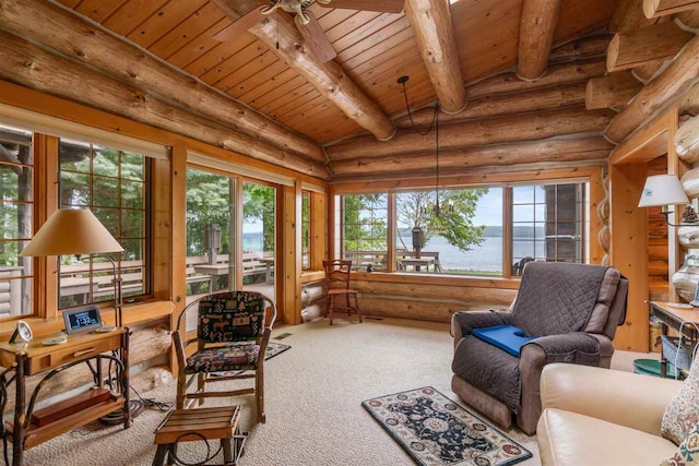 sunroom / solarium featuring wood ceiling, ceiling fan, beamed ceiling, and a water view