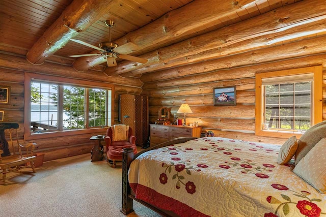 carpeted bedroom with wooden ceiling, beam ceiling, ceiling fan, and rustic walls