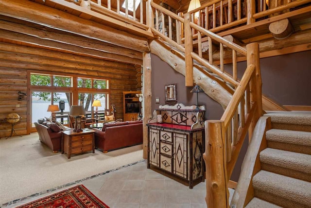 staircase featuring tile patterned flooring, a towering ceiling, and rustic walls