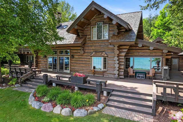 rear view of house featuring a patio area, a wooden deck, and french doors