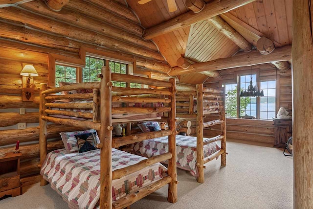 carpeted bedroom with wood ceiling, beamed ceiling, multiple windows, and log walls