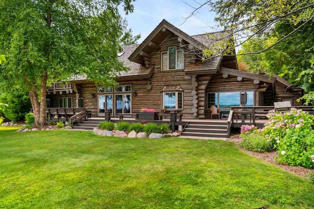 rear view of property featuring a yard and a deck