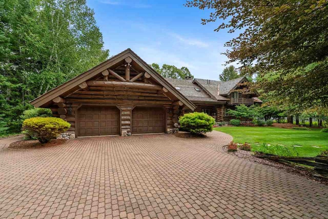 view of front of property with a garage and a front yard