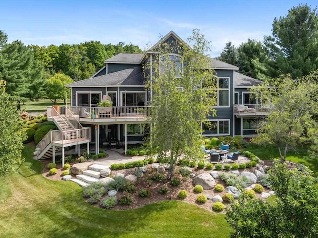 rear view of house featuring a patio area, a deck, and a yard