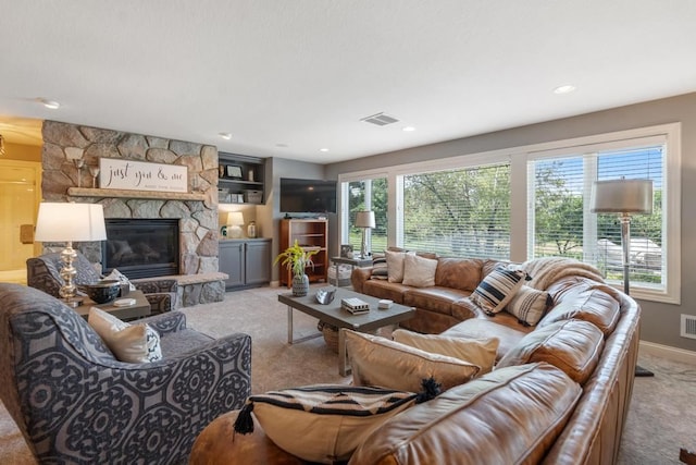 carpeted living room featuring a fireplace and a healthy amount of sunlight