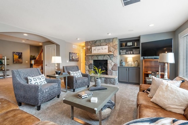 carpeted living room featuring a fireplace