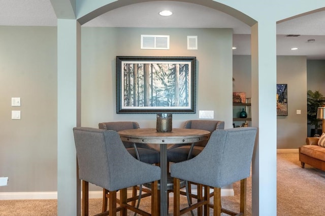 dining room featuring light colored carpet