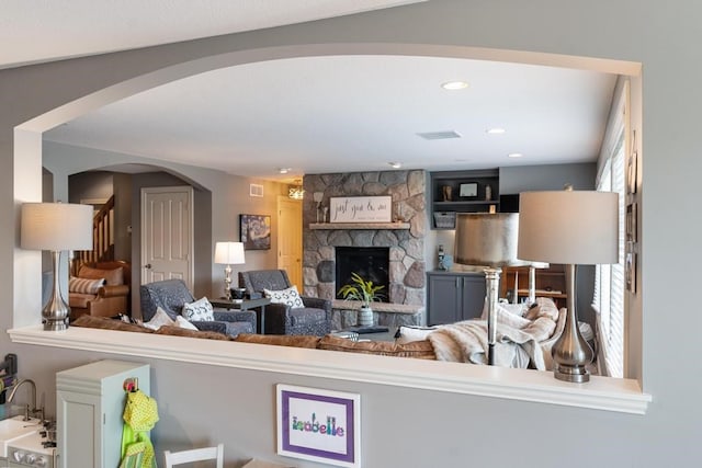 living room with a stone fireplace