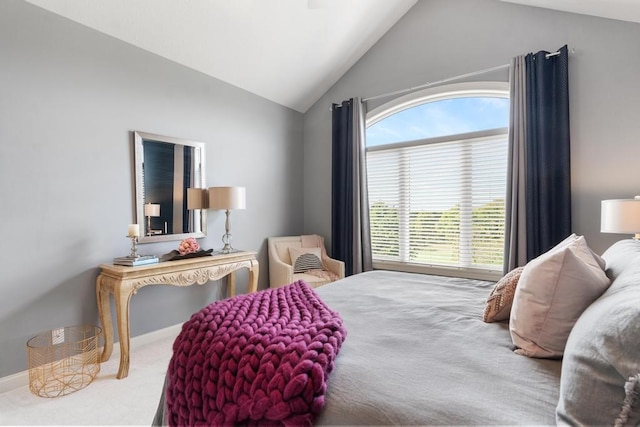 bedroom featuring carpet, vaulted ceiling, and multiple windows