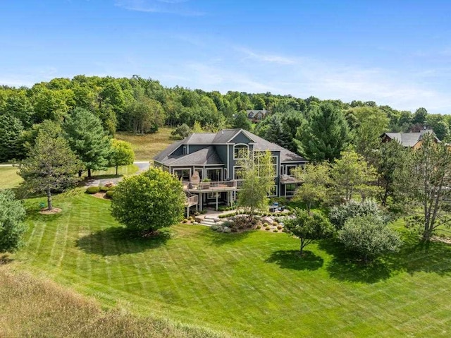 rear view of property featuring a lawn and a wooden deck