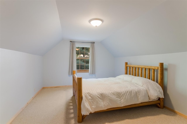 bedroom with carpet flooring and vaulted ceiling