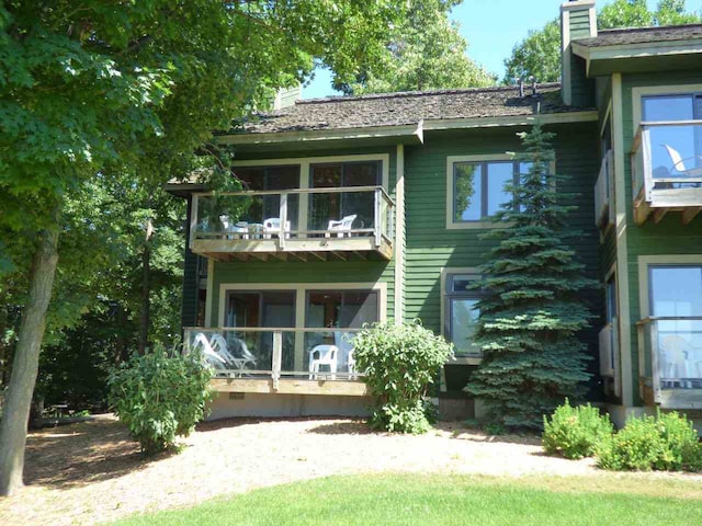 back of property with a balcony