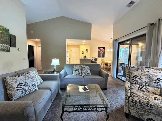 living room with high vaulted ceiling and carpet