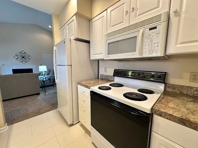 kitchen featuring white cabinets, white appliances, light tile patterned floors, and vaulted ceiling