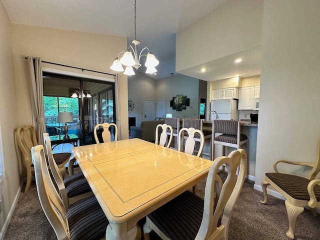 dining area with vaulted ceiling, dark carpet, and a notable chandelier