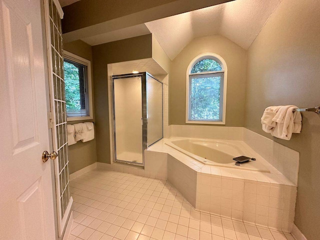 bathroom with tile patterned flooring, separate shower and tub, a textured ceiling, and vaulted ceiling